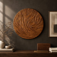 Detail of round wooden wall relief with swirling carved ridges beside wood, brass and linen samples