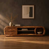 Capsule tv stand with drawers and a round open cubby in a dark studio against a charcoal plaster wall