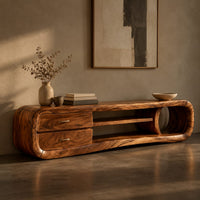 Corner detail of capsule tv stand with drawers and a round open cubby beside wood, brass and linen samples