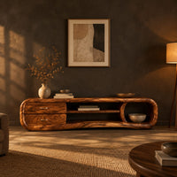 Capsule tv stand with drawers and a round open cubby in a dark living room at golden hour