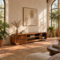 Capsule tv stand with drawers and a round open cubby in a bright living room with arched windows and plants