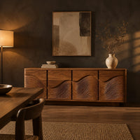 Rounded sideboard with ribbed wave carving on four doors in a dark dining room at golden hour