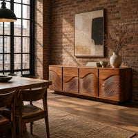 Rounded sideboard with ribbed wave carving on four doors in an industrial loft dining room with exposed brick