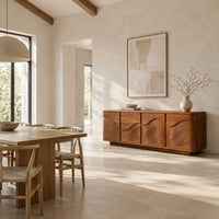 Rounded sideboard with ribbed wave carving on four doors in a bright open plan dining room