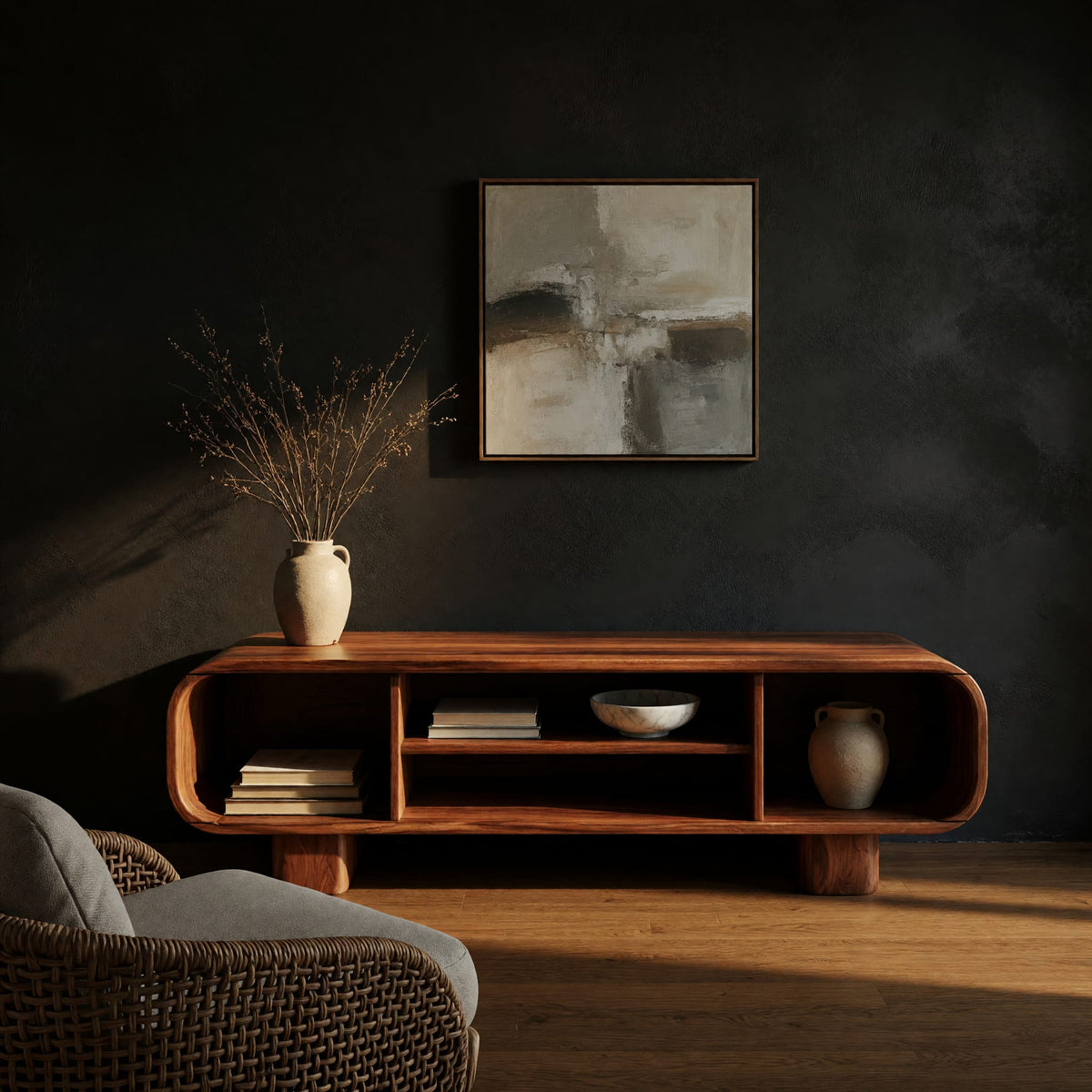 Rounded TV console with three open bays in a dark studio against a charcoal wall