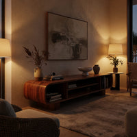 Rounded TV console with three open bays in an evening room lit by two lamps