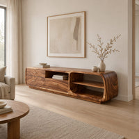 Low rounded tv stand with three drawers and open shelves in a Scandinavian living room with white walls
