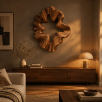 Ruffled wooden wall sculpture with an open star shaped center above a low console in an evening living room