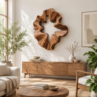 Ruffled wooden wall sculpture with an open star shaped center in a bright sunroom with green plants