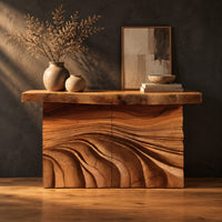 Console table with rough slab top and dune carved base in a dark studio against a charcoal plaster wall