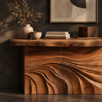 Corner detail of console table with rough slab top and dune carved base beside wood, brass and linen samples