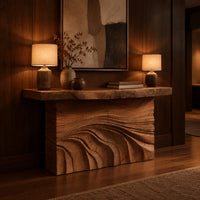 Console table with rough slab top and dune carved base in an evening entryway with walnut wall paneling