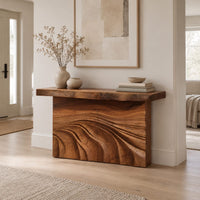 Console table with rough slab top and dune carved base in a Scandinavian entryway with white walls