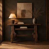 Rustic plank top console table with cutout slab legs and two cross rails in a dark entryway at golden hour