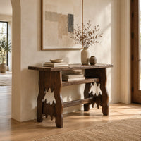 Rustic plank top console table with cutout slab legs and two cross rails in a bright open plan entryway