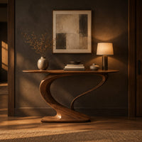 Oval top console table on a sweeping s curve pedestal base in a dark entryway at golden hour
