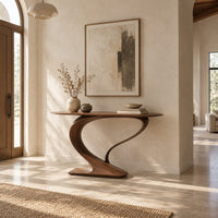 Oval top console table on a sweeping s curve pedestal base in a bright open plan entryway