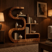 Wooden bookshelf with a thick s shaped curve and stepped open shelves in an evening living room with walnut wall paneling