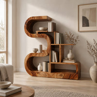 Wooden bookshelf with a thick s shaped curve and stepped open shelves in a Scandinavian living room with white walls