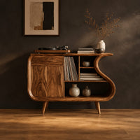 Record player stand with an s shaped side, one door and open shelves in a dark studio against a charcoal plaster wall