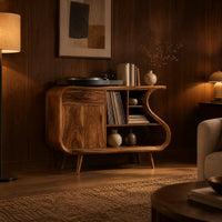 Record player stand with an s shaped side, one door and open shelves in an evening living room with walnut wall paneling