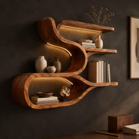 Corner detail of sculpted wood shelf with an open loop cubby and three narrow ledges beside wood, brass and linen samples