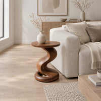Side table with a twisting pedestal and a coiled loop base in a Scandinavian living room with white walls