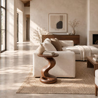 Side table with a twisting pedestal and a coiled loop base in a bright open plan living room