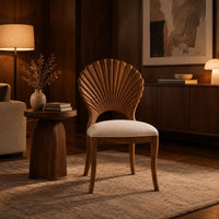 Dining chair with a carved fan shaped back and cushioned seat in an evening living room with walnut wall paneling