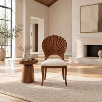 Dining chair with a carved fan shaped back and cushioned seat in a bright open plan living room