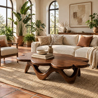 Petal edged coffee table on a rolling arched base in a bright living room with arched windows and plants
