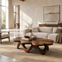 Petal edged coffee table on a rolling arched base in a bright open plan living room