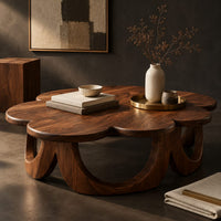 Corner detail of scalloped coffee table on a ring of arched wooden panels beside wood, brass and linen samples