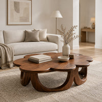Scalloped coffee table on a ring of arched wooden panels in a Scandinavian living room with white walls