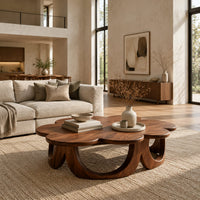 Scalloped coffee table on a ring of arched wooden panels in a bright open plan living room