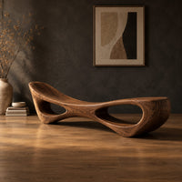 Scooped seat bench with two open oval cutouts in its body in a dark studio against a charcoal plaster wall