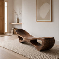 Scooped seat bench with two open oval cutouts in its body in a Scandinavian entryway with white walls