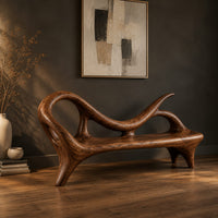 Bench with a looping scroll back and a flat seat on splayed legs, three-quarter view showing the grain