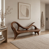 Bench with a looping scroll back and a flat seat on splayed legs in a Scandinavian entryway with white walls