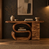 Console table with a large scroll base and a wave carved side column in a dark entryway at golden hour