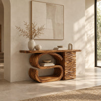 Console table with a large scroll base and a wave carved side column in a bright open plan entryway