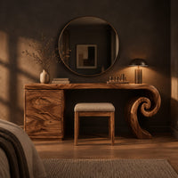 Makeup vanity desk with a spiral scroll leg and a three drawer cabinet in a dark bedroom at golden hour