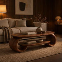 Oval coffee table with scrolled end supports and a lower oval shelf in an evening living room with walnut wall paneling