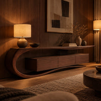 Tv stand with a sweeping scroll end and a three panel cabinet in an evening living room with walnut wall paneling