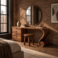 Makeup vanity with four drawers and a sweeping top ending in a scroll leg in an industrial loft bedroom with exposed brick