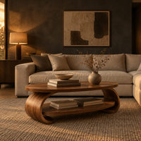Oval coffee table with scrolled sides and a low shelf in a dark living room at golden hour