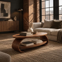Oval coffee table with scrolled sides and a low shelf in an industrial loft living room with exposed brick