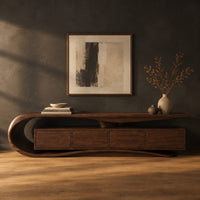 Low tv stand with a scroll end top, four front panels and wavy base in a dark studio against a charcoal plaster wall