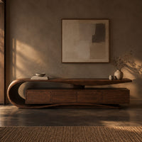 Corner detail of low tv stand with a scroll end top, four front panels and wavy base beside wood, brass and linen samples
