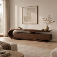 Low tv stand with a scroll end top, four front panels and wavy base in a Scandinavian living room with white walls